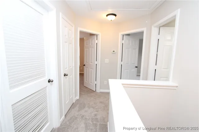 a view of a hallway with a cabinet and mirror