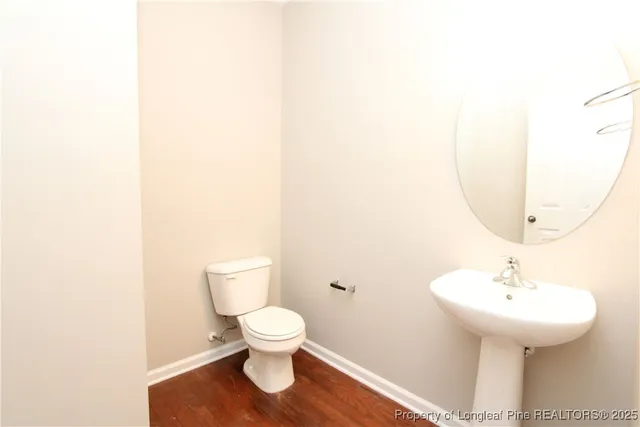 a bathroom with a sink toilet and a mirror