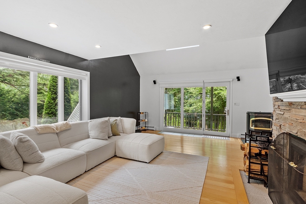 18 Crane Crossing Road Plaistow, NH 03865 - Photo 13 of 36 a living room with furniture a flat screen tv and a large window