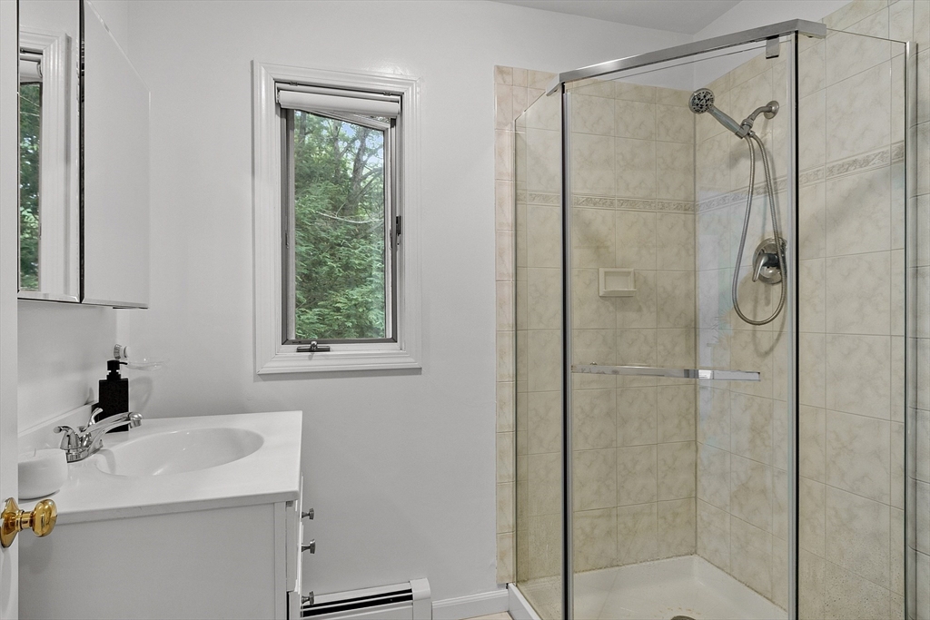 18 Crane Crossing Road Plaistow, NH 03865 - Photo 19 of 36 a bathroom with a sink a mirror and shower