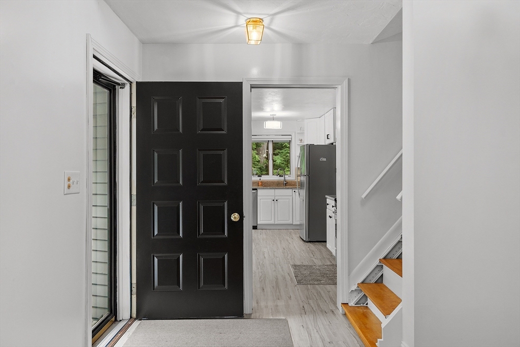 18 Crane Crossing Road Plaistow, NH 03865 - Photo 20 of 36 hallway with wooden floor and stairs