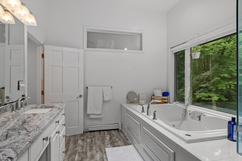 18 Crane Crossing Road Plaistow, NH 03865 - Photo 32 of 36 a bathroom with a granite countertop tub sink and mirror