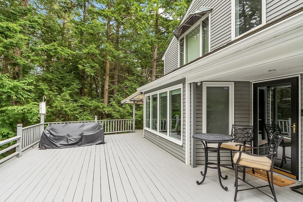 18 Crane Crossing Road Plaistow, NH 03865 - Photo 8 of 36 a view of a patio with table and chairs and wooden floor
