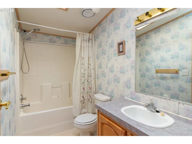 a bathroom with a sink toilet tub and shower