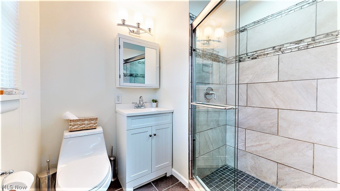 3586 Oak Road Stow, OH 44224 - Photo 21 of 34 *LUXURIOUS MASTER BATHROOM W/SLATE GREY TILED FLOOR, WHITE VANITY, SINK AND MEDICINE CABINET, DUAL FLUSH COMFORT HEIGHT TOILET, FRAMELESS DOORS AND CUSTOM TILED SHOWER!! ~
