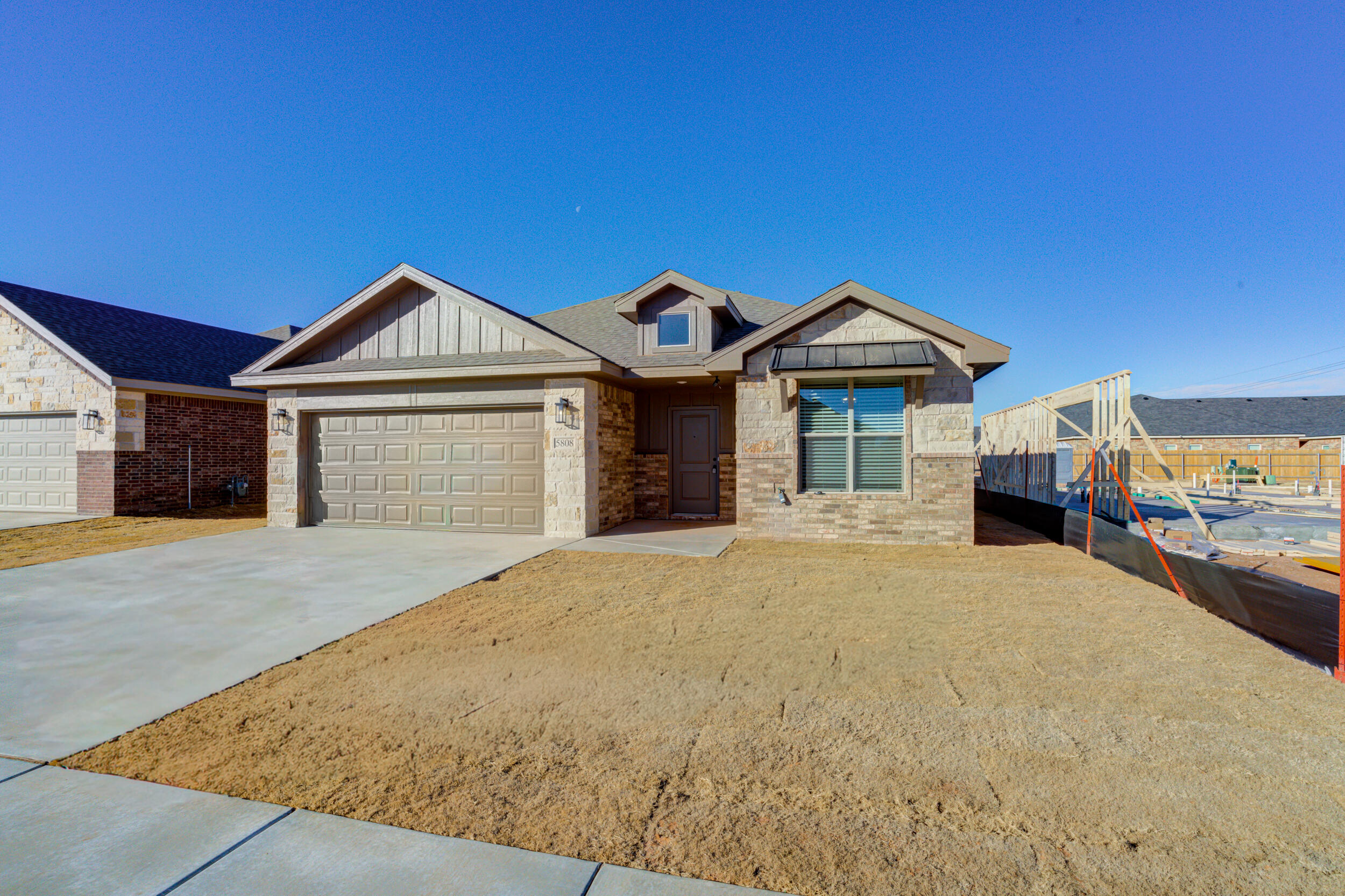 5808 Viola Avenue Lubbock, TX 79407 - Photo 1 of 60 a front view of a house with a garden and pathway