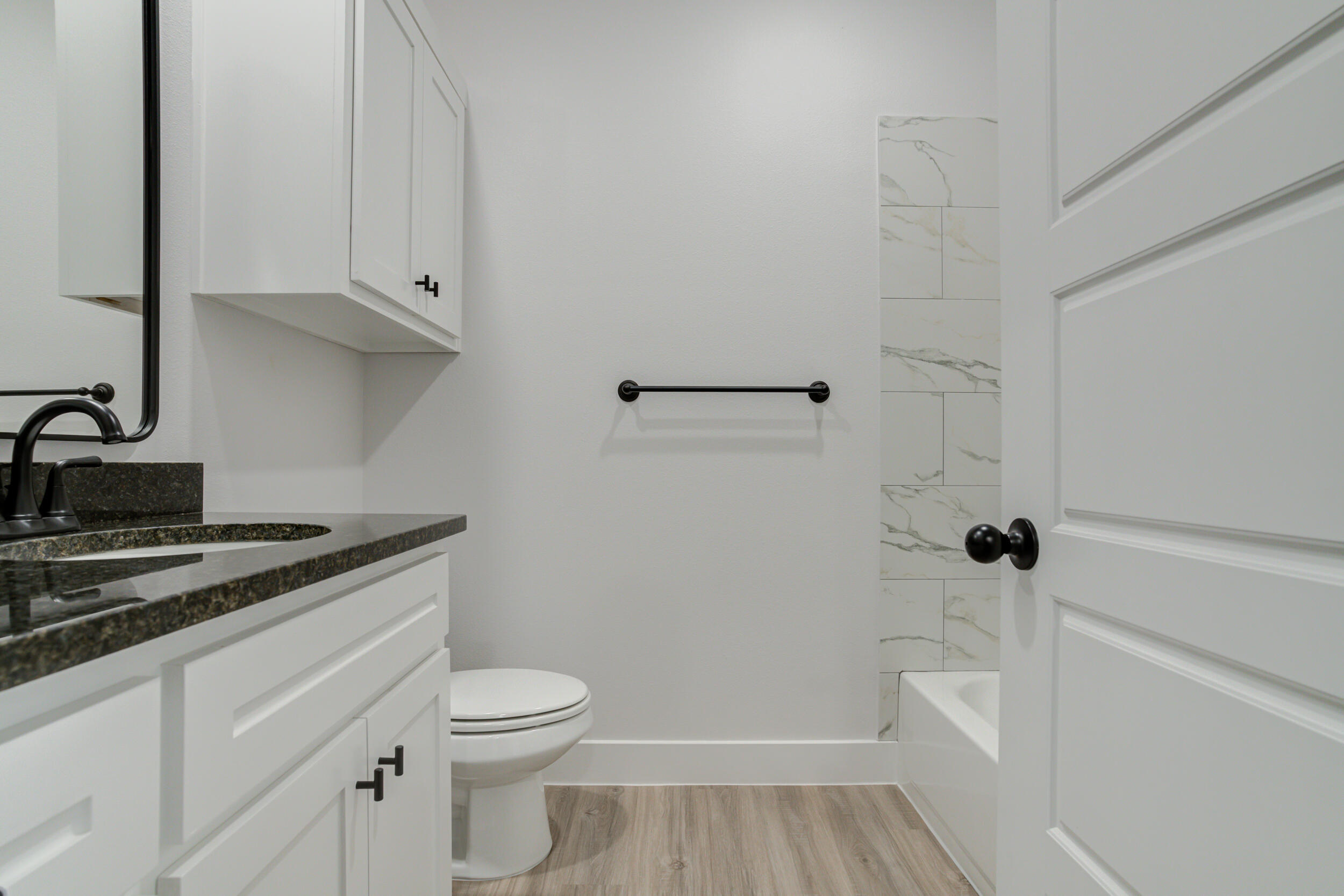 5808 Viola Avenue Lubbock, TX 79407 - Photo 12 of 60 a bathroom with a granite countertop sink toilet and shower