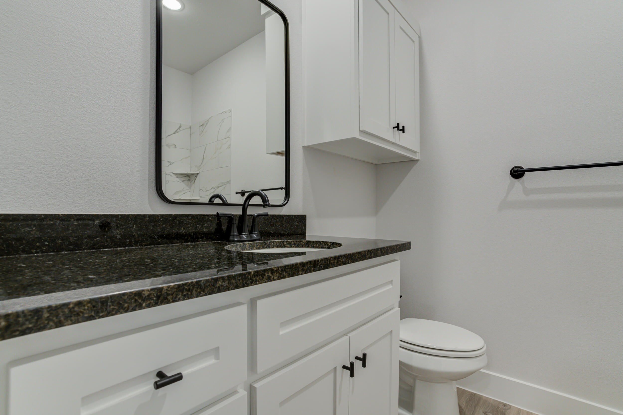 5808 Viola Avenue Lubbock, TX 79407 - Photo 13 of 60 a bathroom with a sink and a toilet