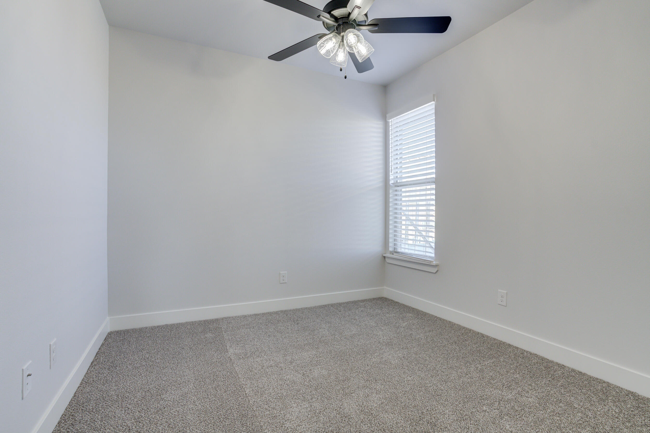 5808 Viola Avenue Lubbock, TX 79407 - Photo 16 of 60 an empty room with windows and fan