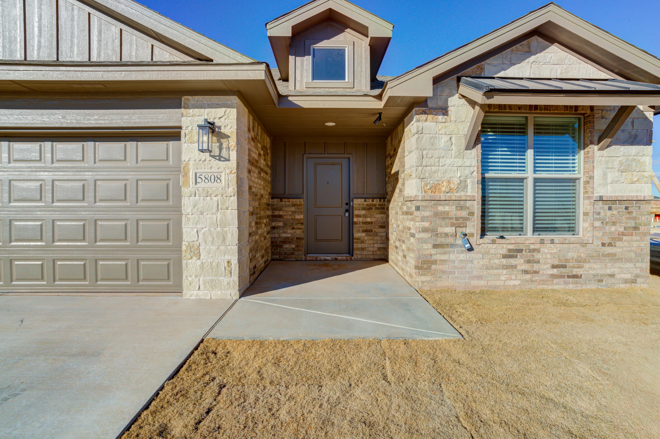 5808 Viola Avenue Lubbock, TX 79407 - Photo 2 of 60 a front view of a house with a yard