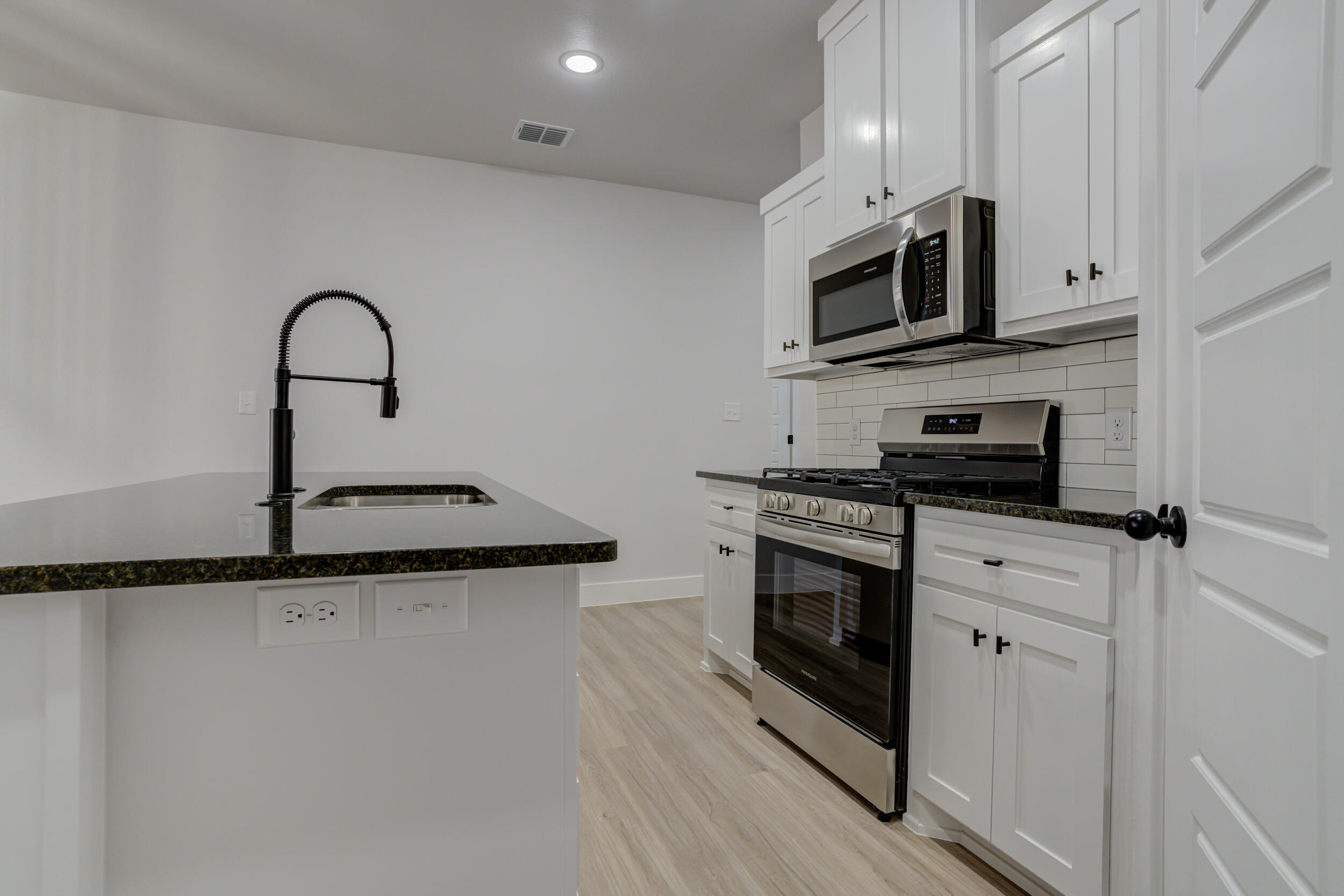 5808 Viola Avenue Lubbock, TX 79407 - Photo 22 of 60 a kitchen with stainless steel appliances granite countertop a stove microwave and a sink