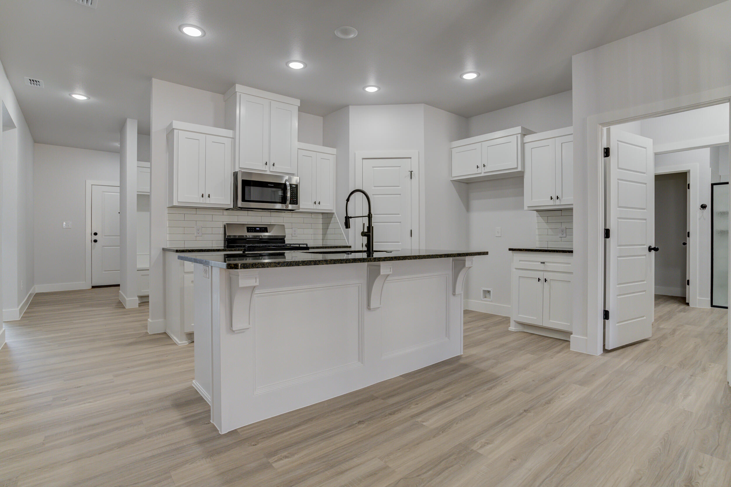5808 Viola Avenue Lubbock, TX 79407 - Photo 25 of 60 a kitchen with granite countertop a refrigerator and a stove top oven