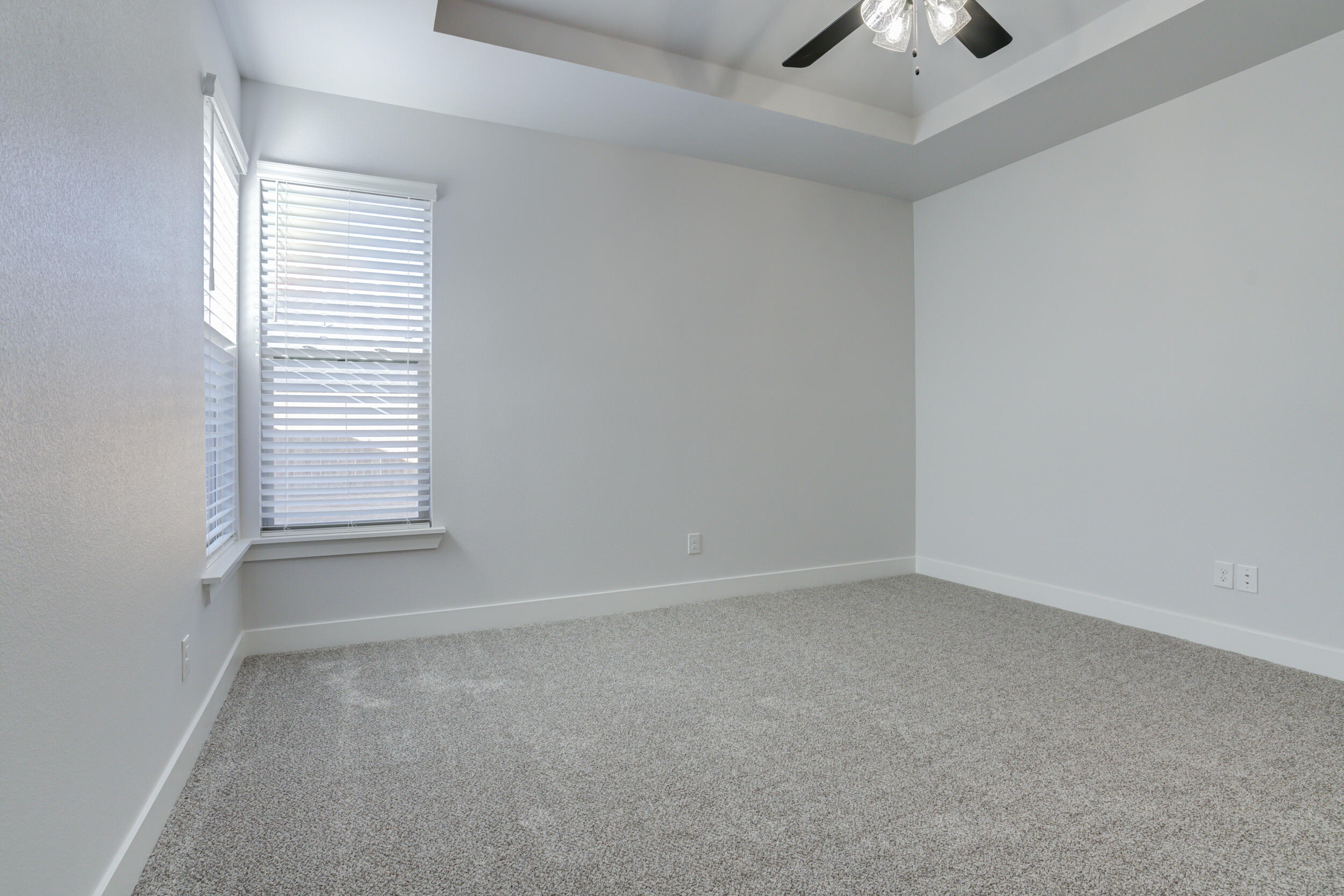 5808 Viola Avenue Lubbock, TX 79407 - Photo 38 of 60 an empty room with a window and a ceiling fan