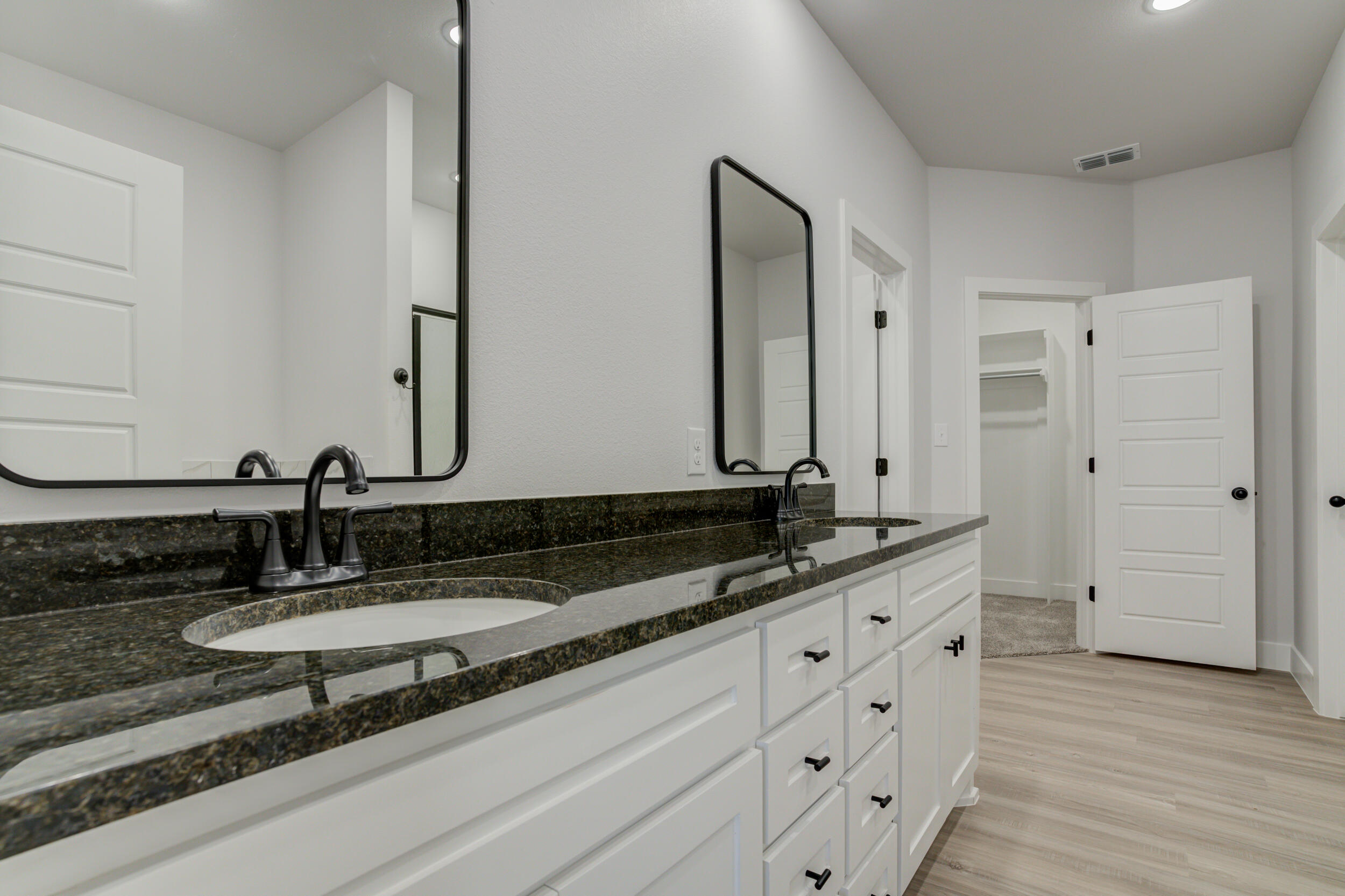 5808 Viola Avenue Lubbock, TX 79407 - Photo 42 of 60 a bathroom with double sink and a mirror