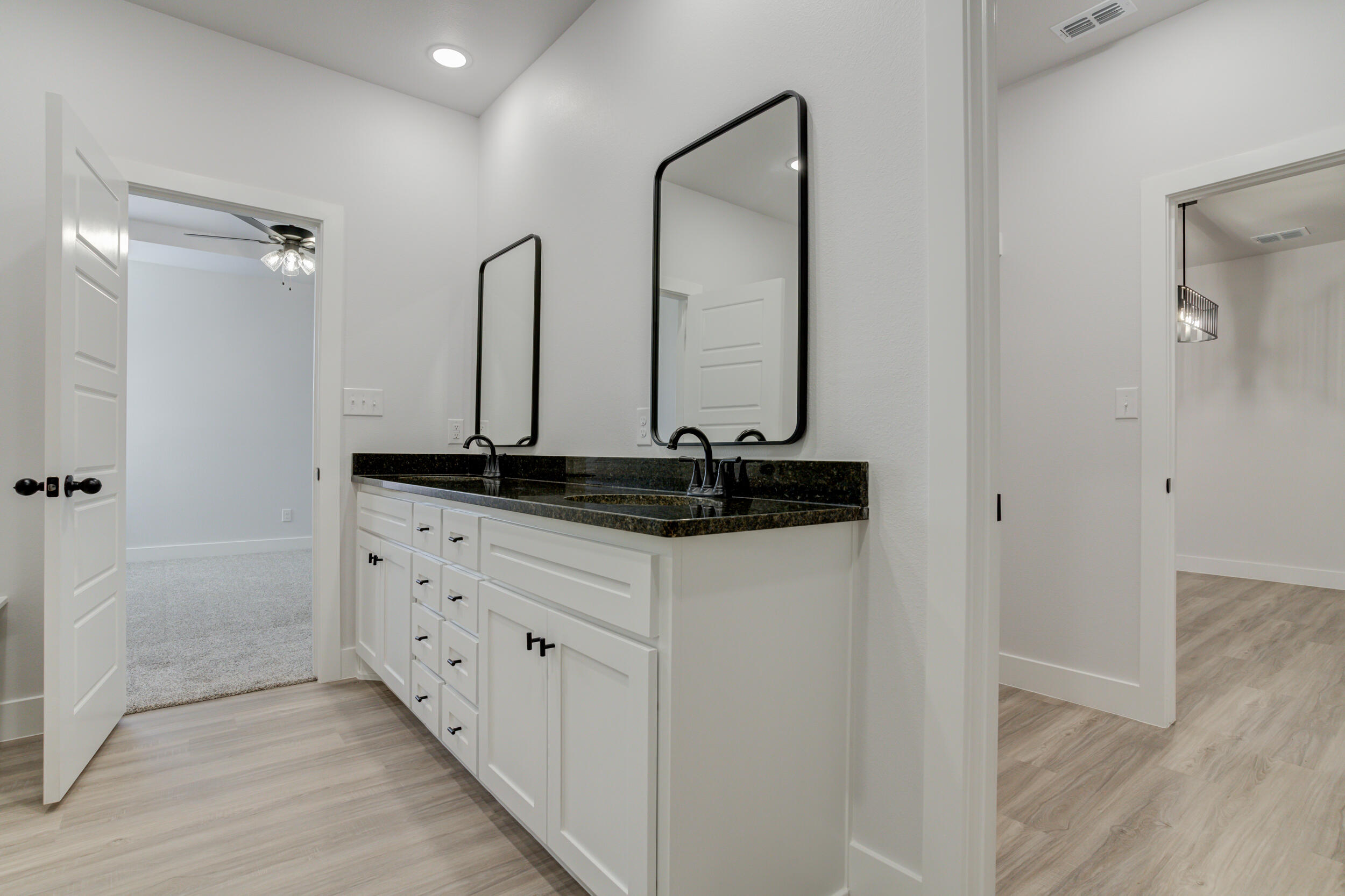 5808 Viola Avenue Lubbock, TX 79407 - Photo 47 of 60 a bathroom with a granite countertop sink and a mirror