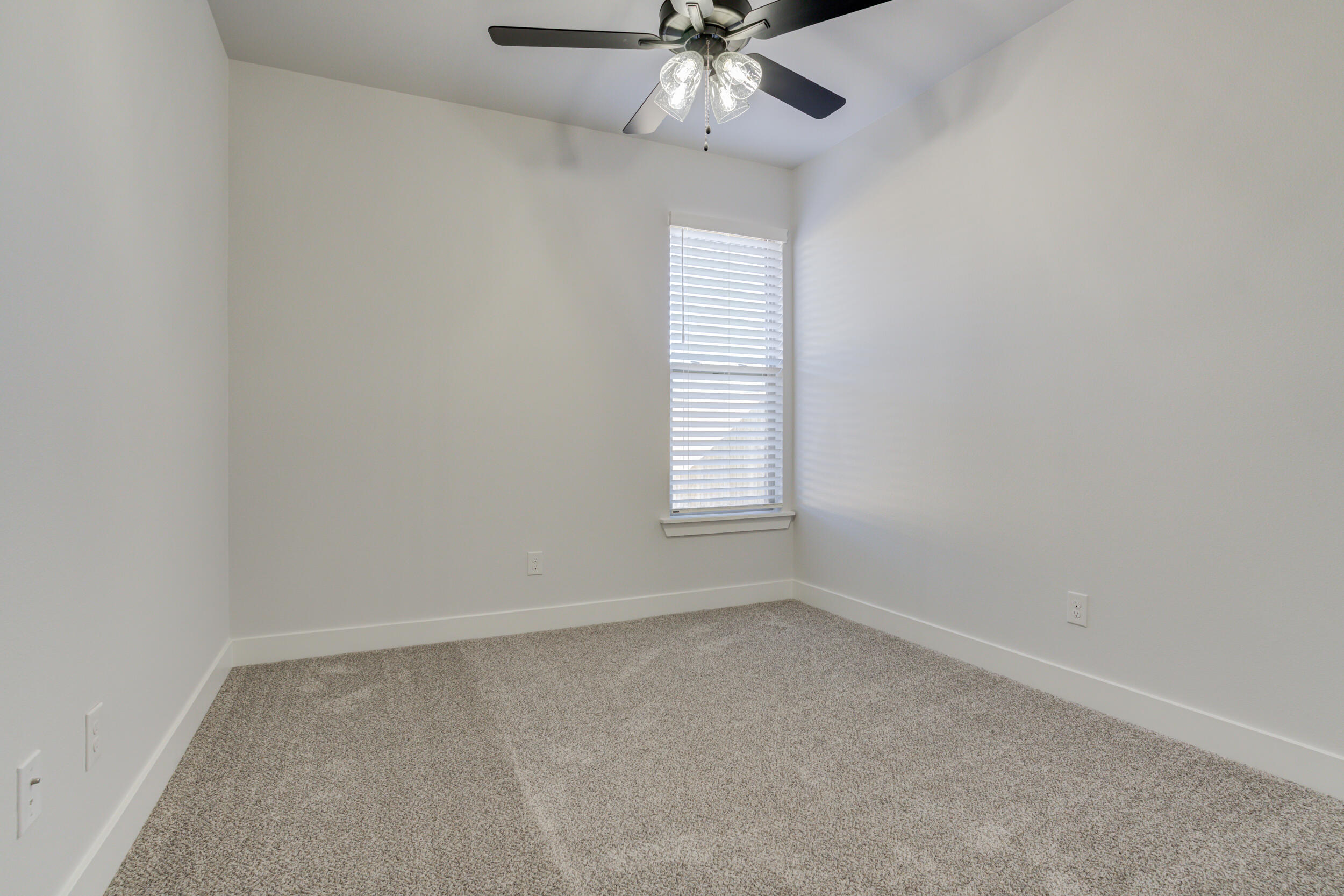 5808 Viola Avenue Lubbock, TX 79407 - Photo 54 of 60 an empty room with a window and a fan