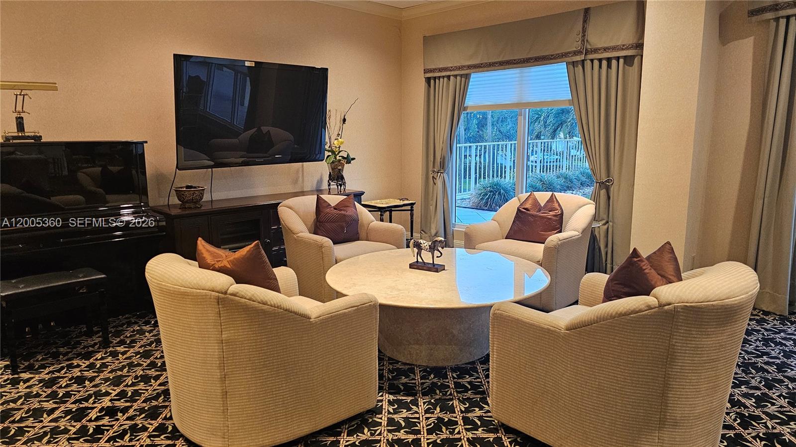 4001 North Ocean Boulevard, Unit 702 Boca Raton, FL 33431 - Photo 52 of 56 a living room with furniture a flat screen tv and a window