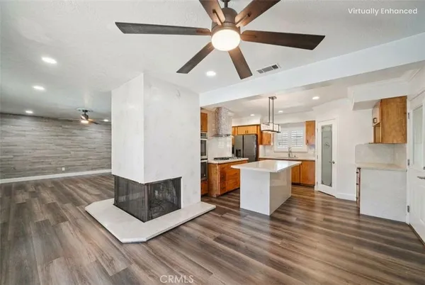 a large kitchen with kitchen island a sink stainless steel appliances and cabinets