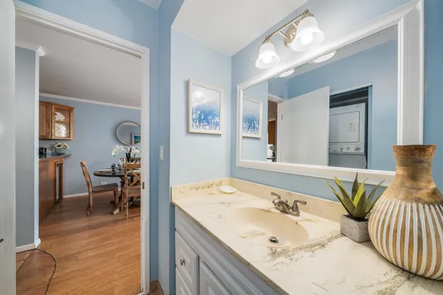a en suite bathroom with a granite countertop sink and a mirror