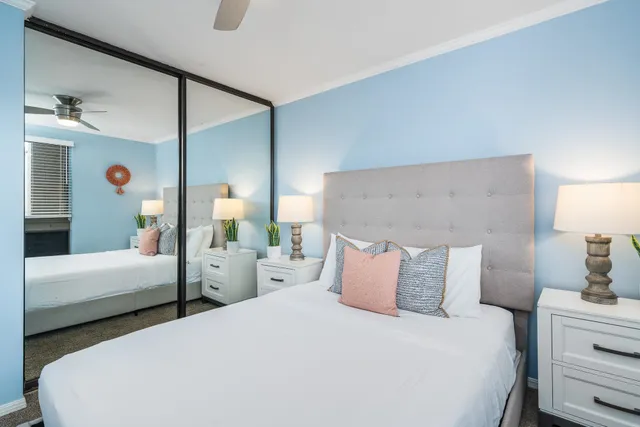 a bedroom with two beds and a large window