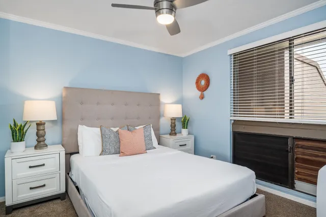 a bedroom with a bed and a window