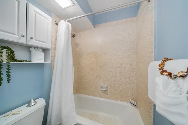 a bathroom with a bathtub and shower