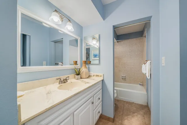 a bathroom with a sink a mirror and a bathtub