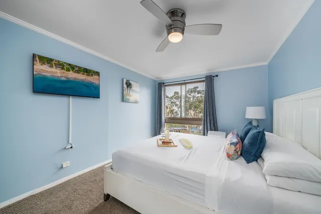 a bedroom with a large bed and a window