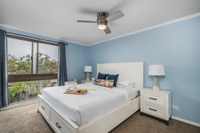 a bedroom with a bed and a large window