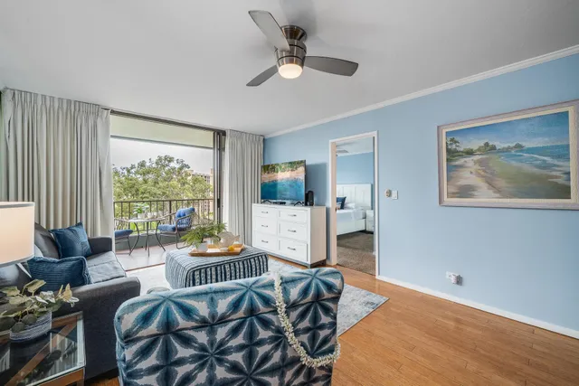 a living room with furniture a flat screen tv and a large window