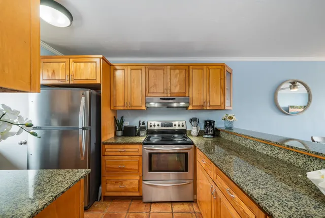 a kitchen with a refrigerator and a sink