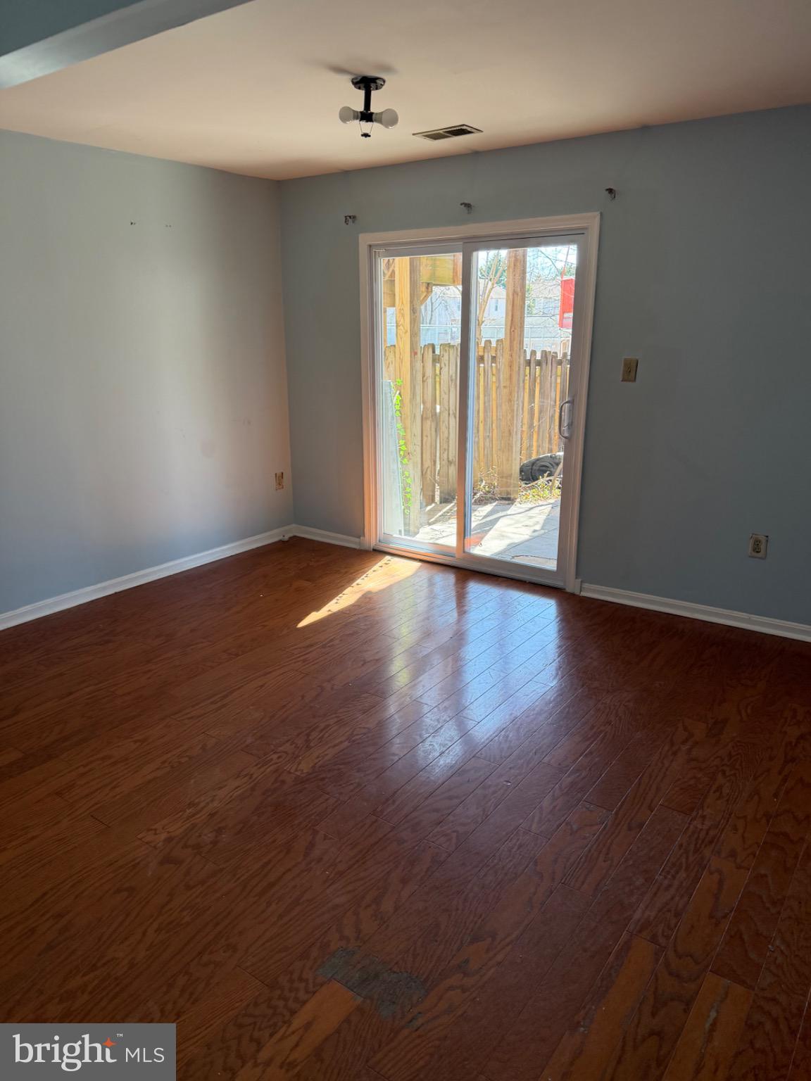 12150 Turnstone Court, Unit 90 Silver Spring, MD 20904 - Photo 13 of 19 an empty room with wooden floor and windows