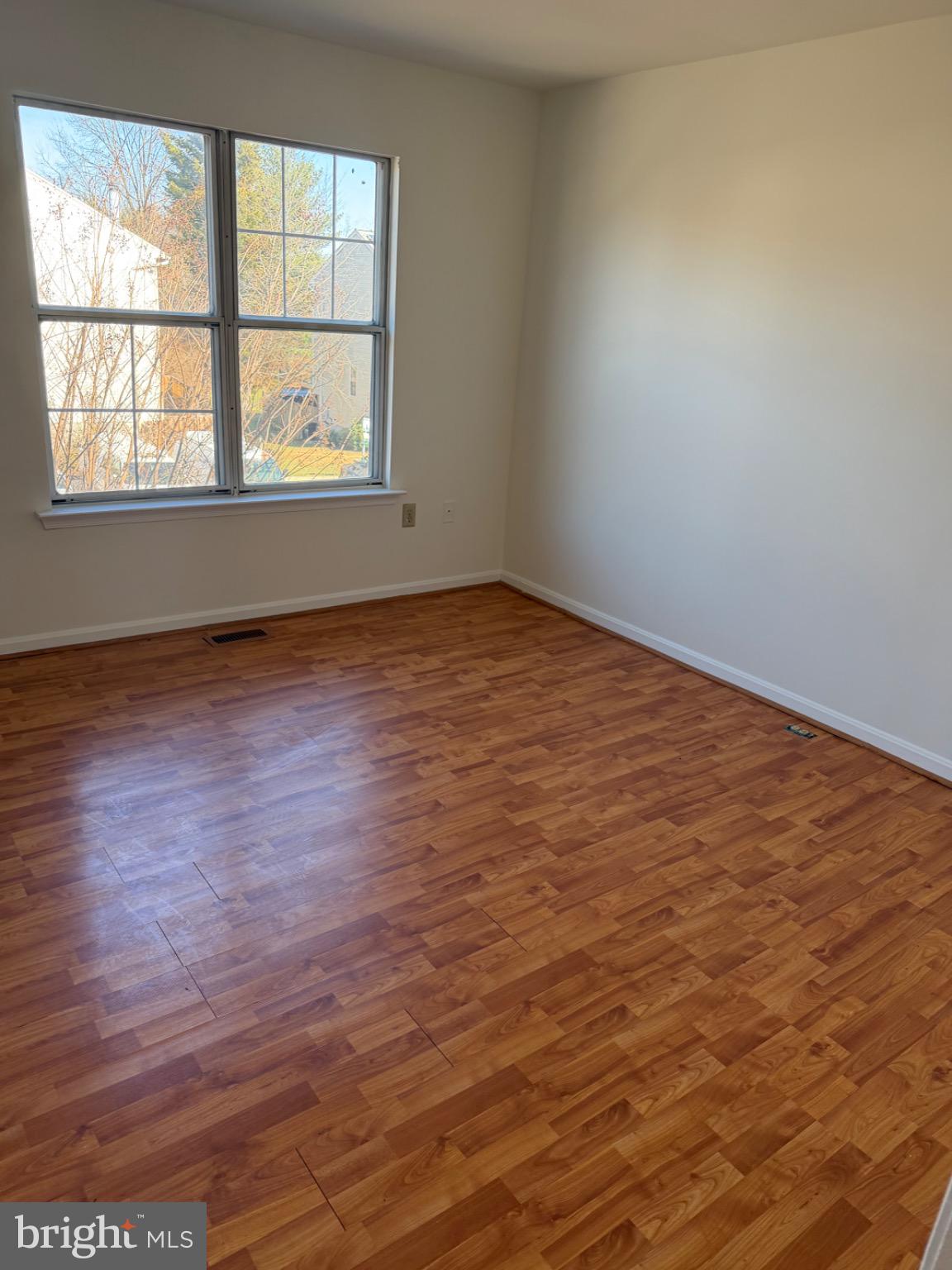 12150 Turnstone Court, Unit 90 Silver Spring, MD 20904 - Photo 15 of 19 an empty room with wooden floor and windows