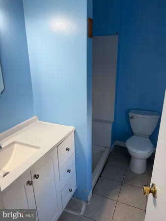 a white toilet sitting next to a bathroom sink