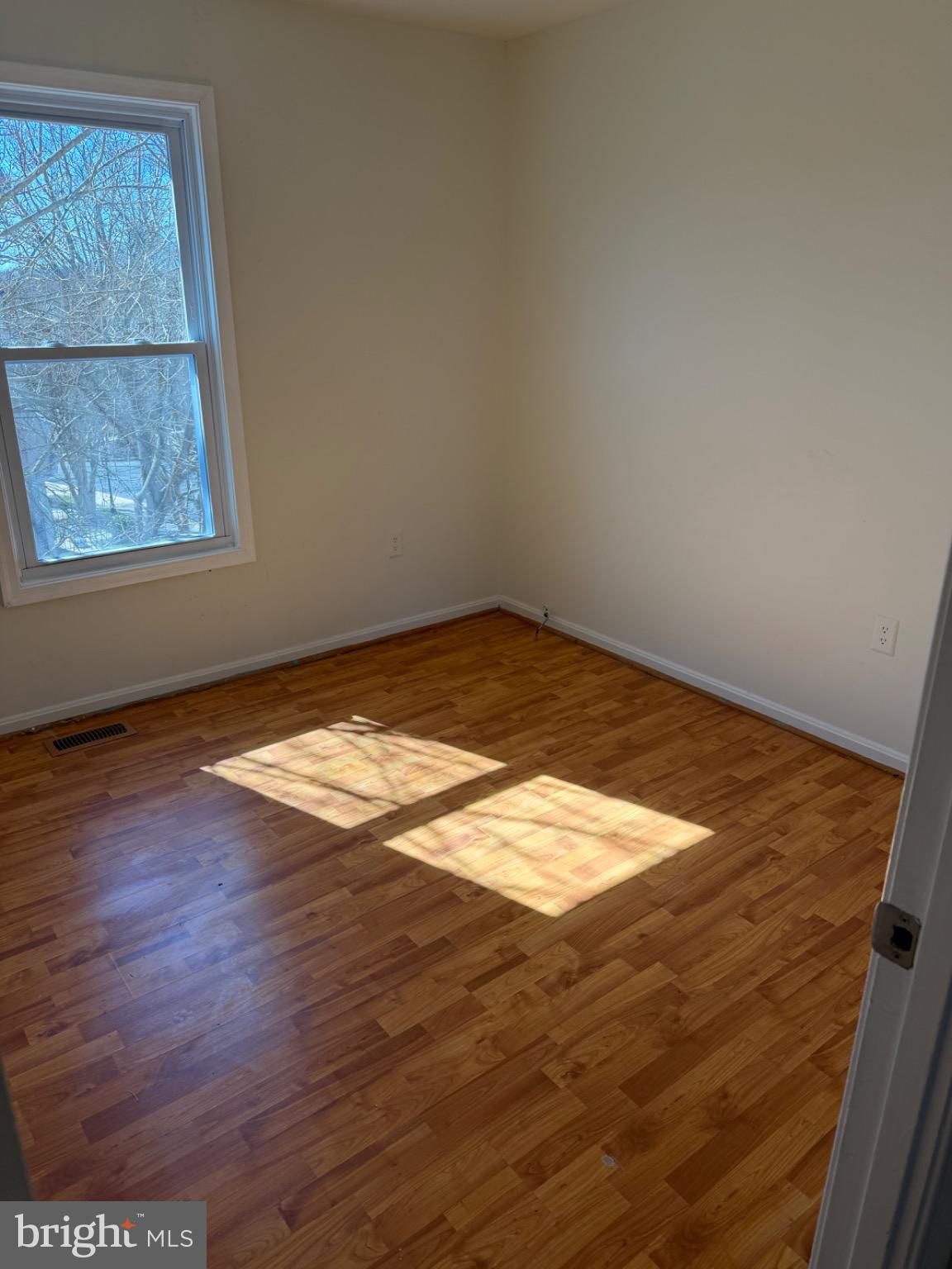 12150 Turnstone Court, Unit 90 Silver Spring, MD 20904 - Photo 19 of 19 an empty room with wooden floor and windows