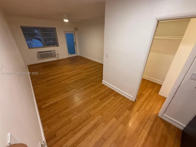 a view of a room with wooden floor