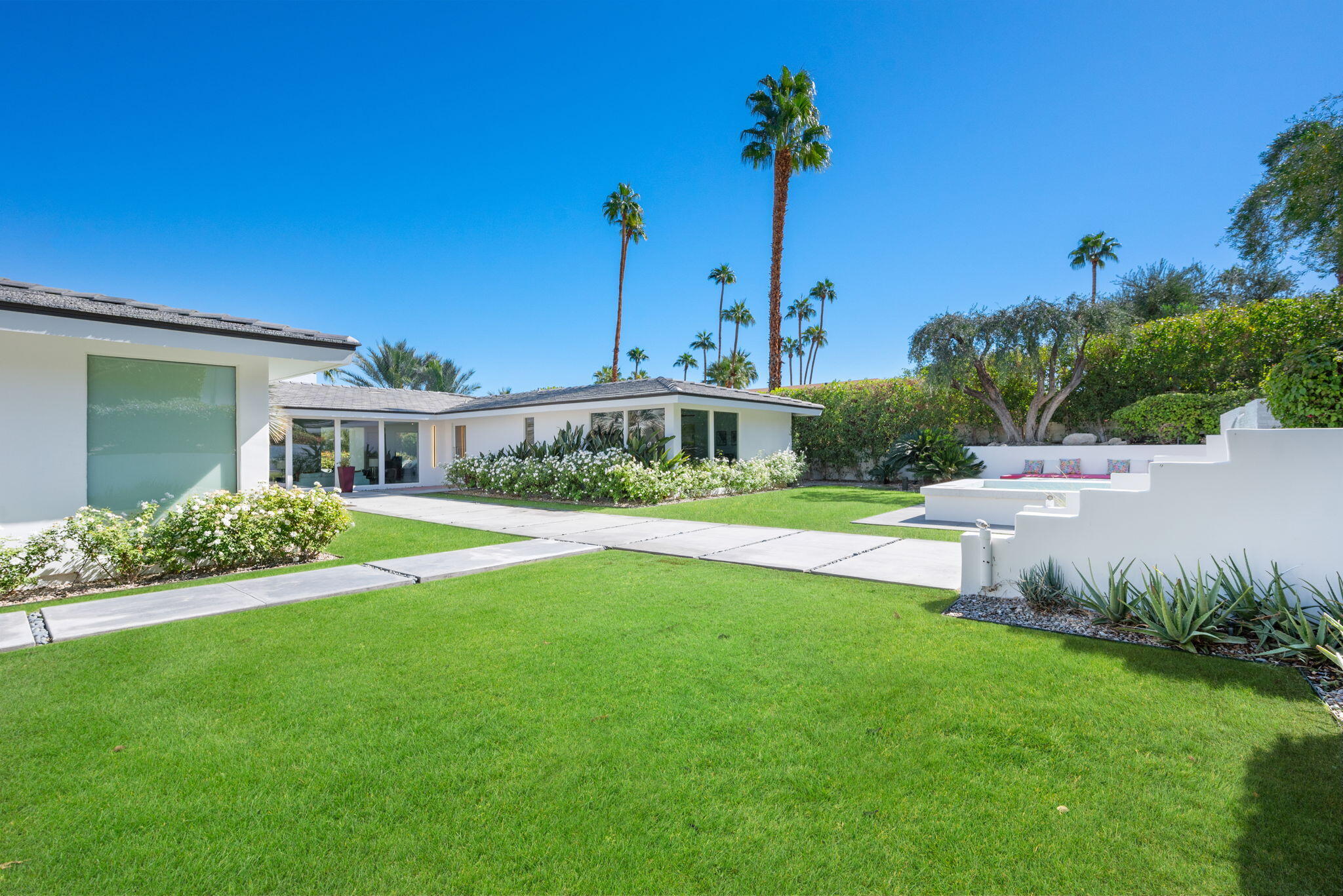 70288 Calico Road Rancho Mirage, CA 92270 - Photo 15 of 72 a front view of a house with garden