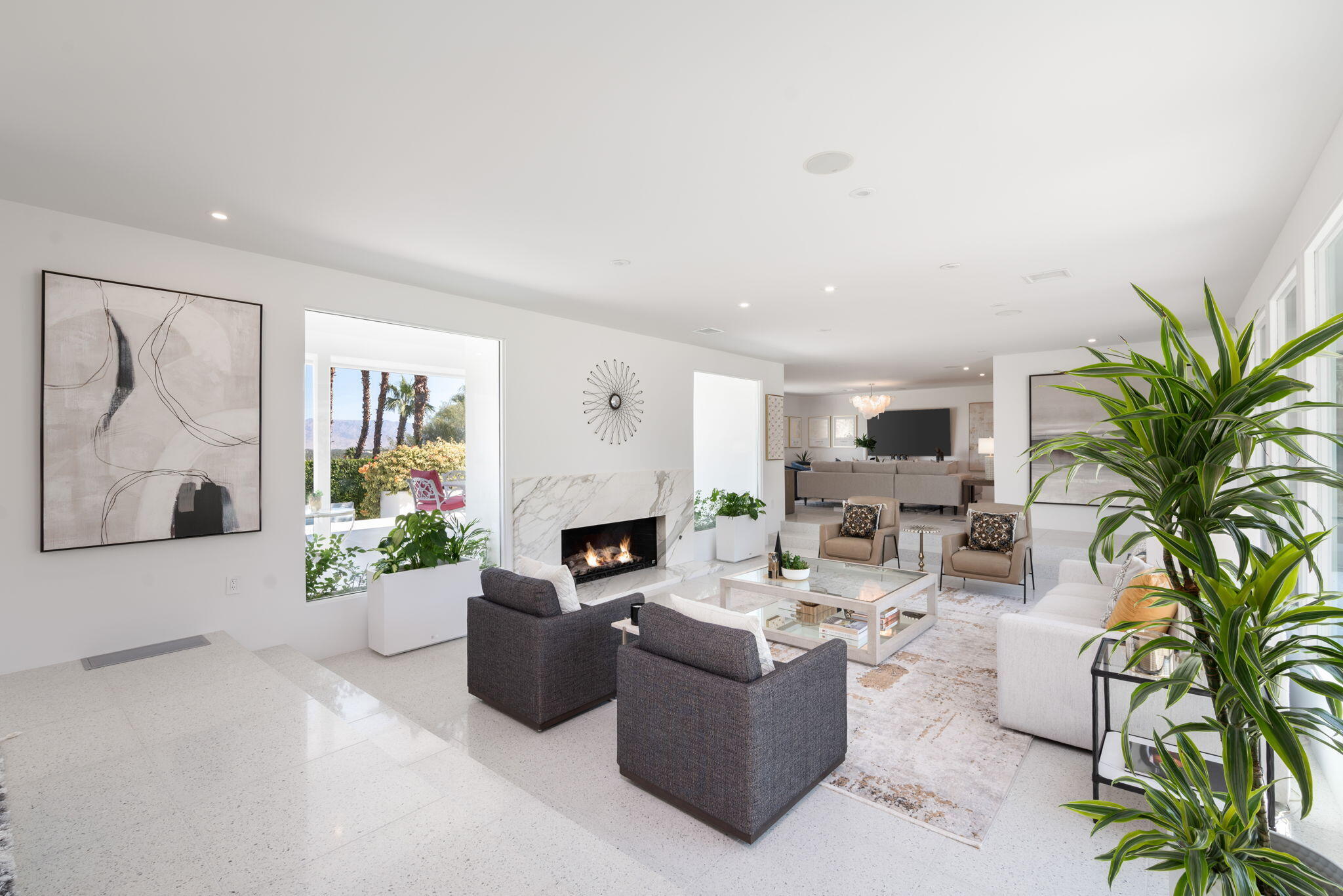 70288 Calico Road Rancho Mirage, CA 92270 - Photo 27 of 72 a living room with furniture a fireplace and a potted plant
