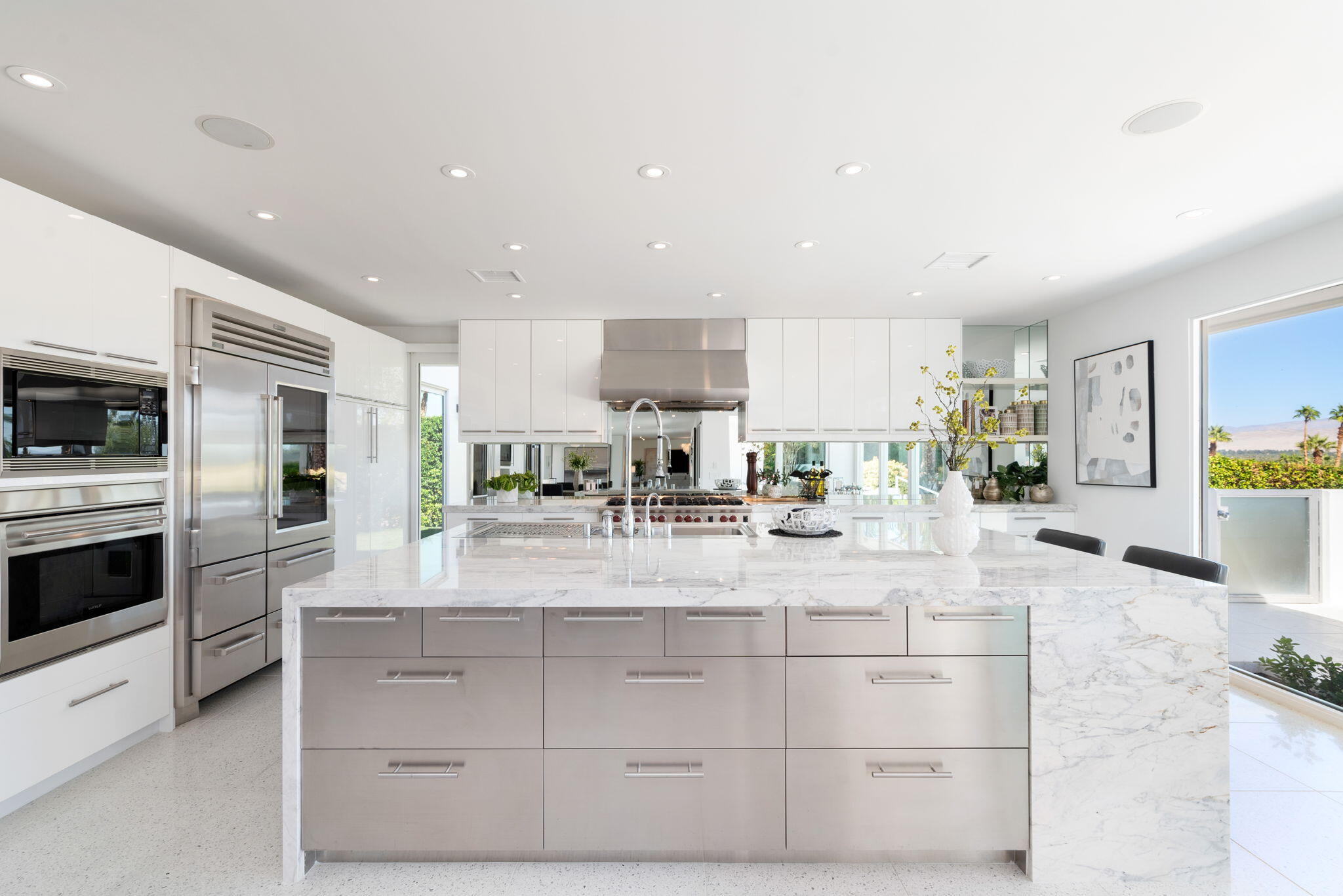 70288 Calico Road Rancho Mirage, CA 92270 - Photo 35 of 72 a view of living room with stainless steel appliances kitchen island granite countertop a stove a sink a refrigerator and cabinets