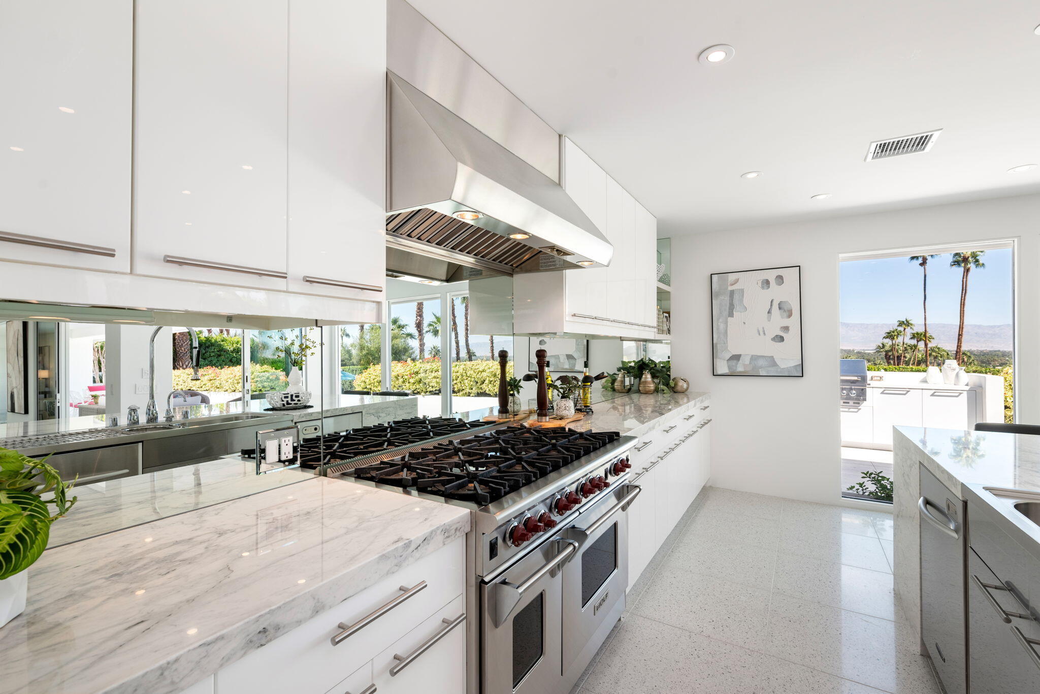 70288 Calico Road Rancho Mirage, CA 92270 - Photo 41 of 72 a kitchen with a stove and a large window