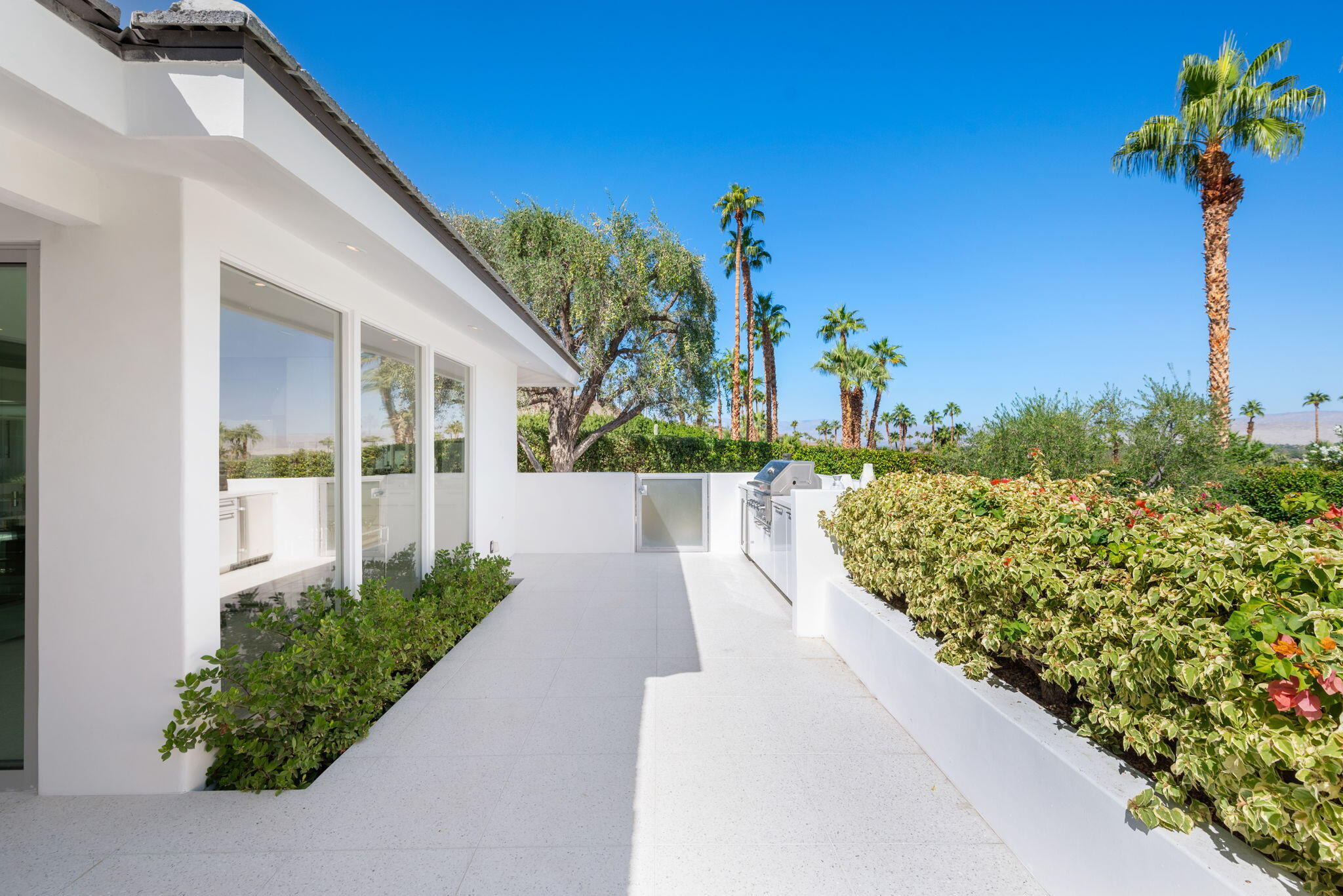 70288 Calico Road Rancho Mirage, CA 92270 - Photo 59 of 72 a view of a garden with a building in the background