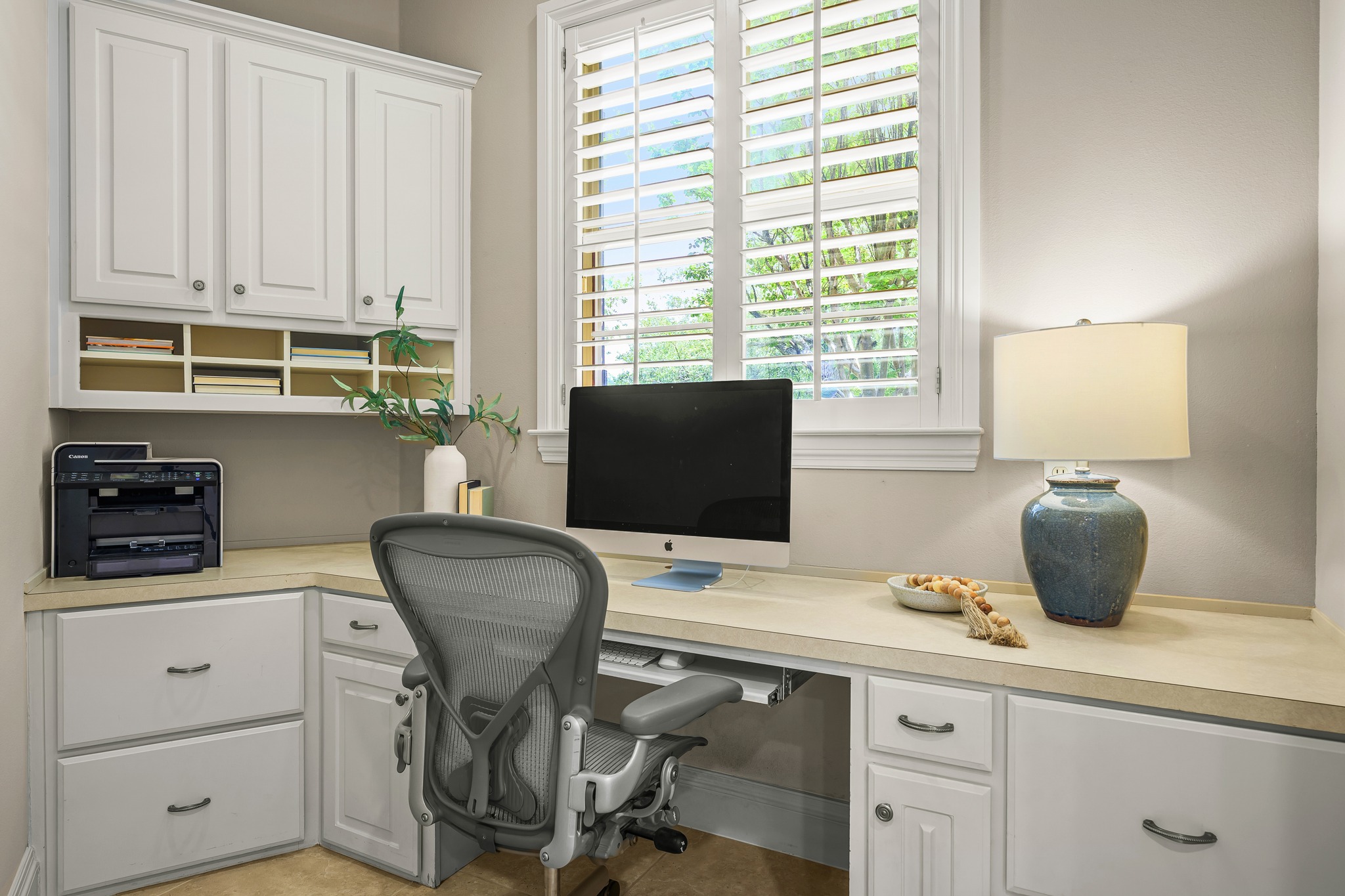 5200 Rico Cove Austin, TX 78731 - Photo 15 of 40 A built-in desk with overhead cabinetry and plantation shutters defines this functional workspace.