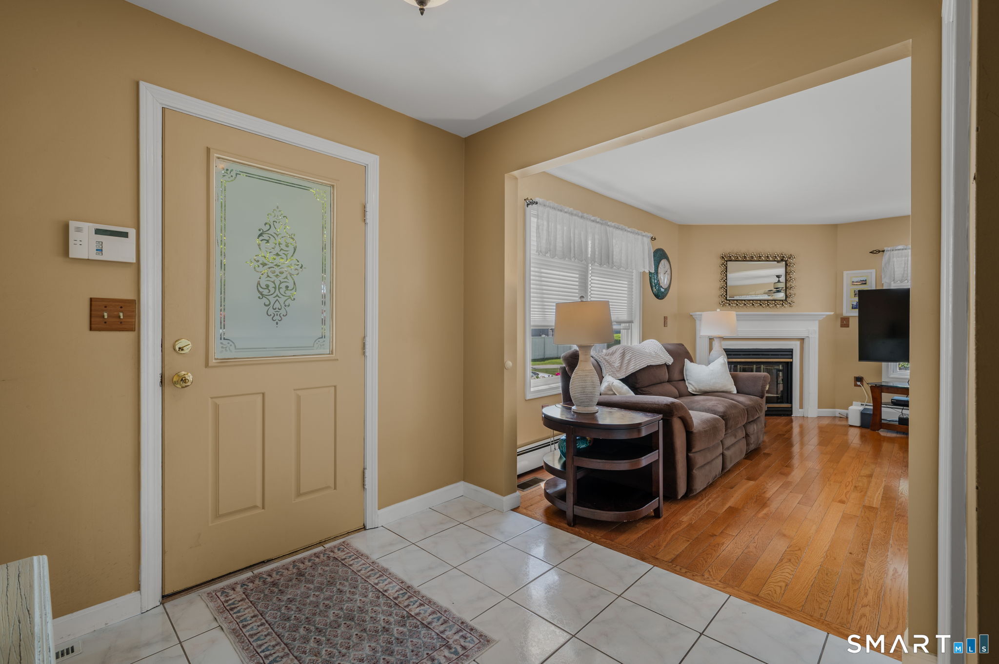 212 R Shore Road Waterford, CT 06385 - Photo 16 of 28 a living room with furniture and a fireplace