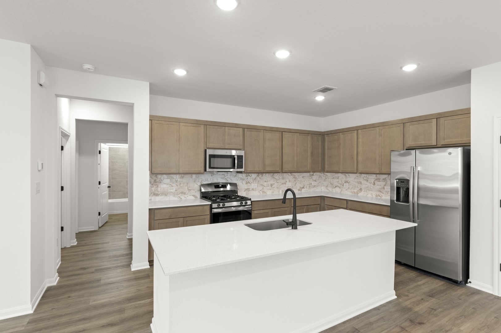 3717 Pin Oak Hills Seguin, TX 78155 - Photo 4 of 22 a kitchen with stainless steel appliances a refrigerator sink and stove