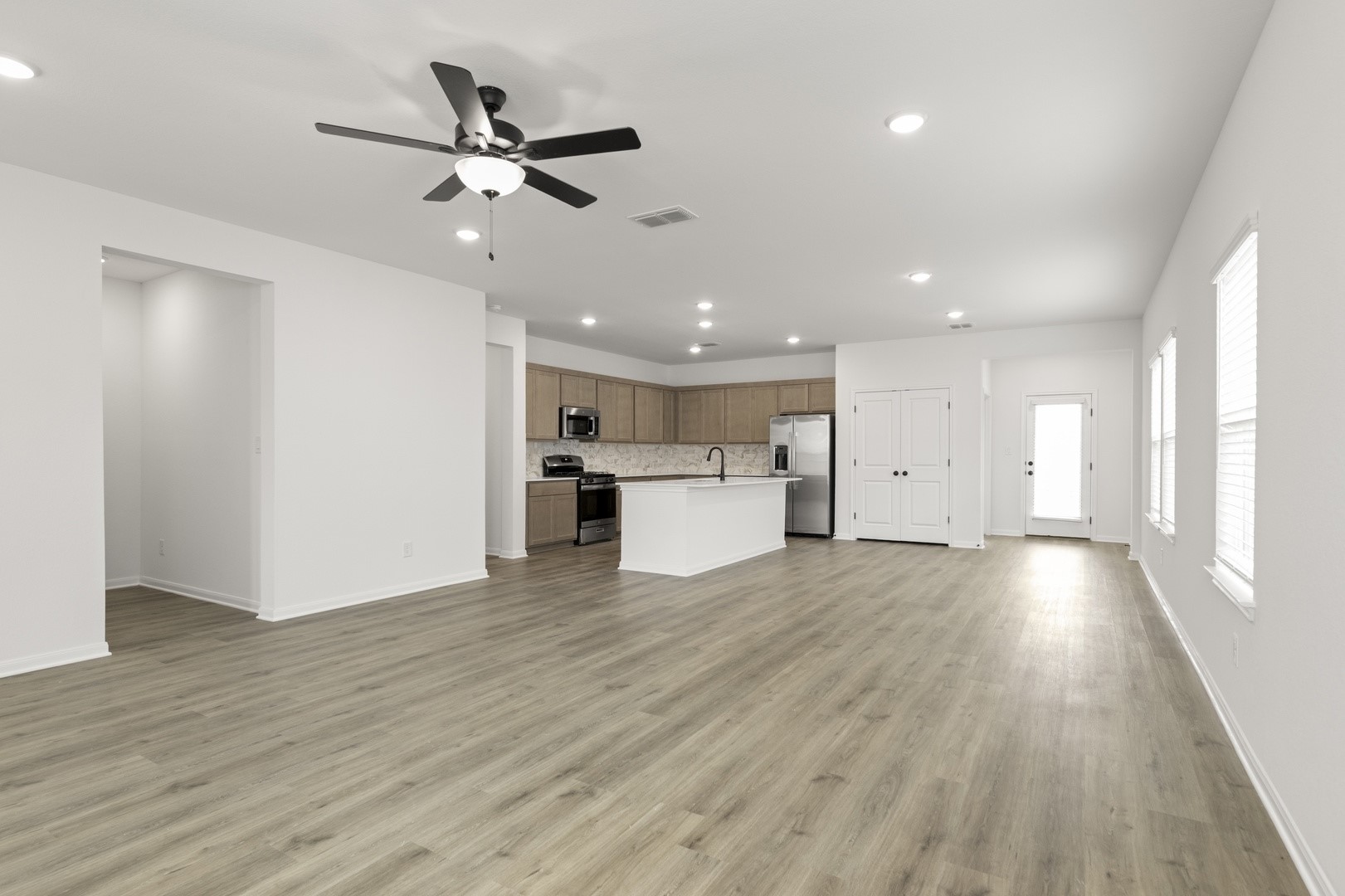 3717 Pin Oak Hills Seguin, TX 78155 - Photo 5 of 22 a view of an empty room with wooden floor and a ceiling fan