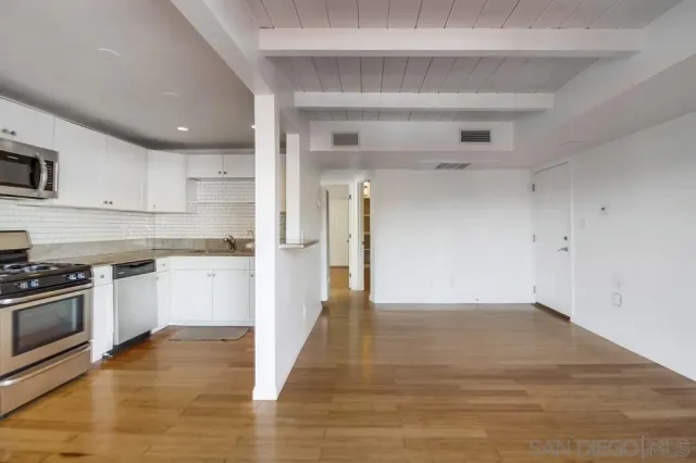 a view of a kitchen with a stove cabinets and wooden floor