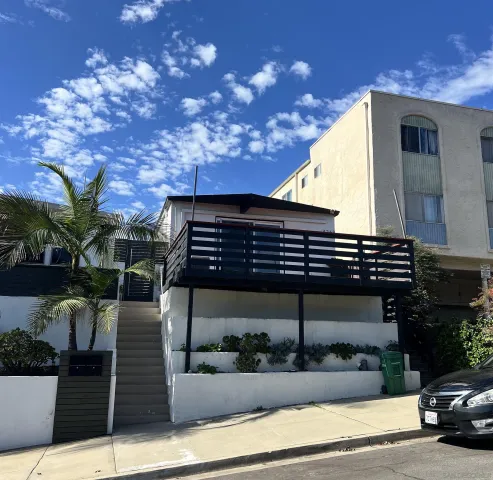 a view of a building with entryway and a yard