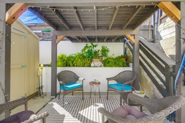 a view of balcony with furniture and garden