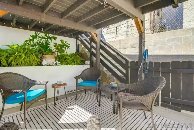 a balcony with table and chairs