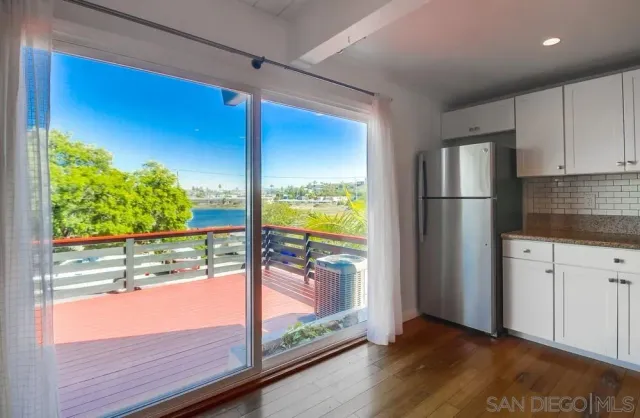 a view of a refrigerator in kitchen and wooden floor